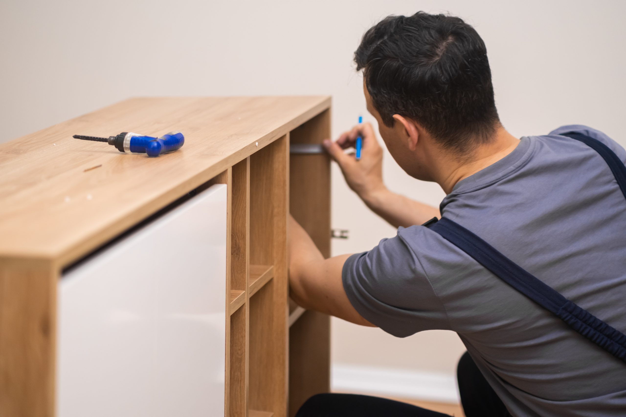 furniture manufacturing fixing carpenter hands installing shelves wooden furniture scaled